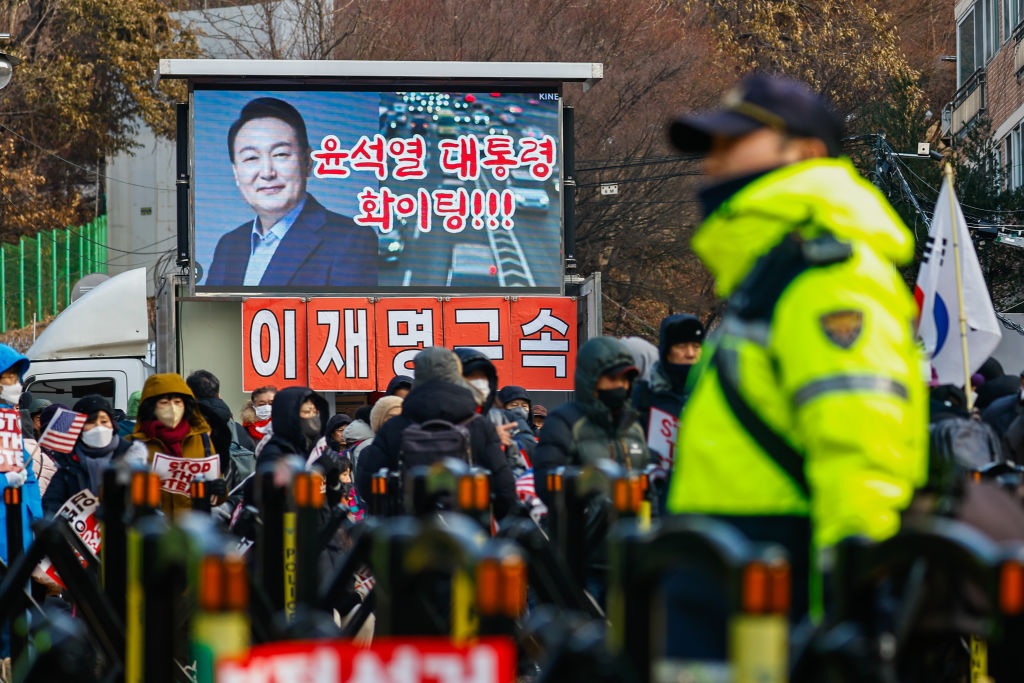 Police officers stand guard as people gather near the presidential residence to show support for impeached President Yoon Suk Yeol after the anti-corruption agency for high-ranking officials received a new court warrant to arrest Yoon, in Seoul, South Korea, January 8, 2025. Photo by Daniel Ceng/Anadolu via Getty Images/Files