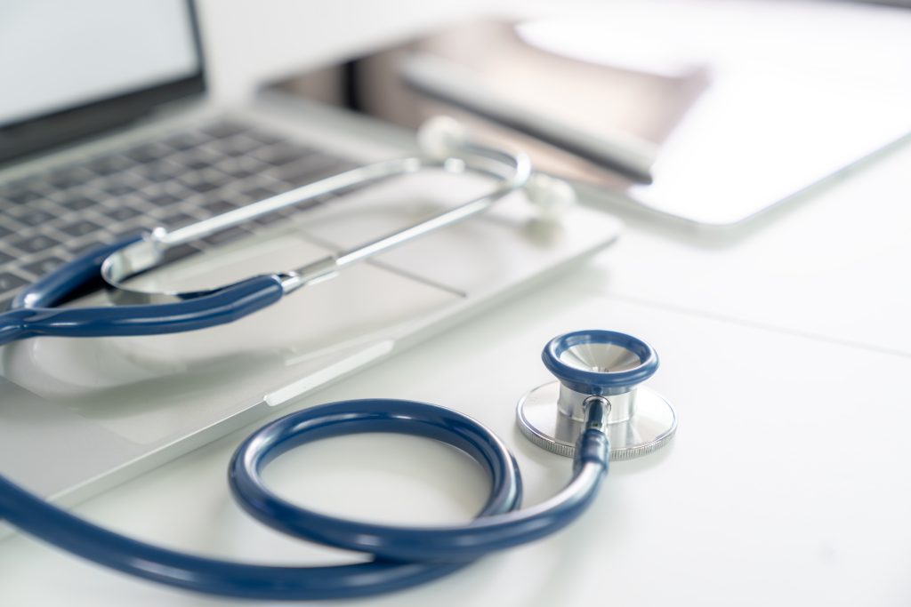 A stethoscope is placed on a doctor's desk in a hospital