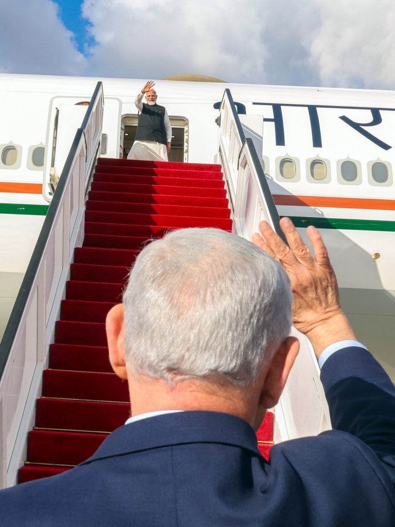 PM Modi and Israeli Prime Minister Benjamin Netanyahu wave to each other as he departs after concluding his state visit