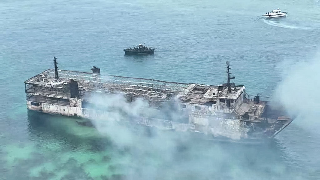 Philippine firefighters enter charred ferry as search continues for dozens missing