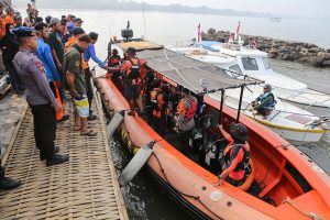 Indonesia rescuers battle turbulent seas in search for 129 people after passenger ship capsizes